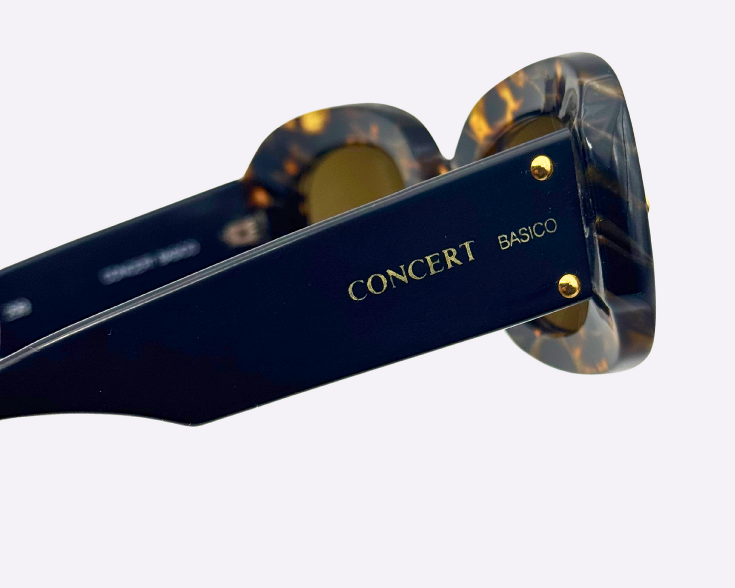 Sunglasses with tortoiseshell frame and navy arms, showing the Concert Basico logo in gold.