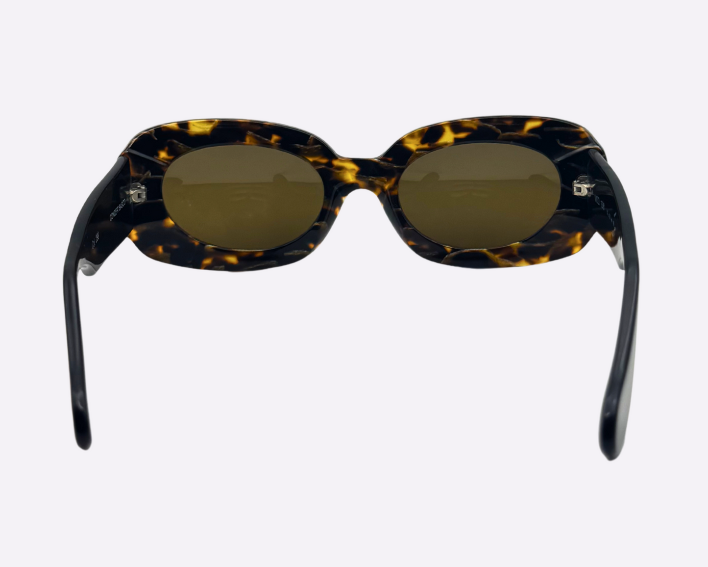Rear view of vintage Concert sunglasses with brown tortoise frames and front-facing gold strass decorations, shown on a light gray background.