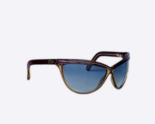 Side view of Christian Dior 2205 Sport sunglasses, made in Germany, with a contoured dark red and yellow frame and brand-new grey gradient lenses, emphasizing the aerodynamic temple shape, shown on a neutral background.