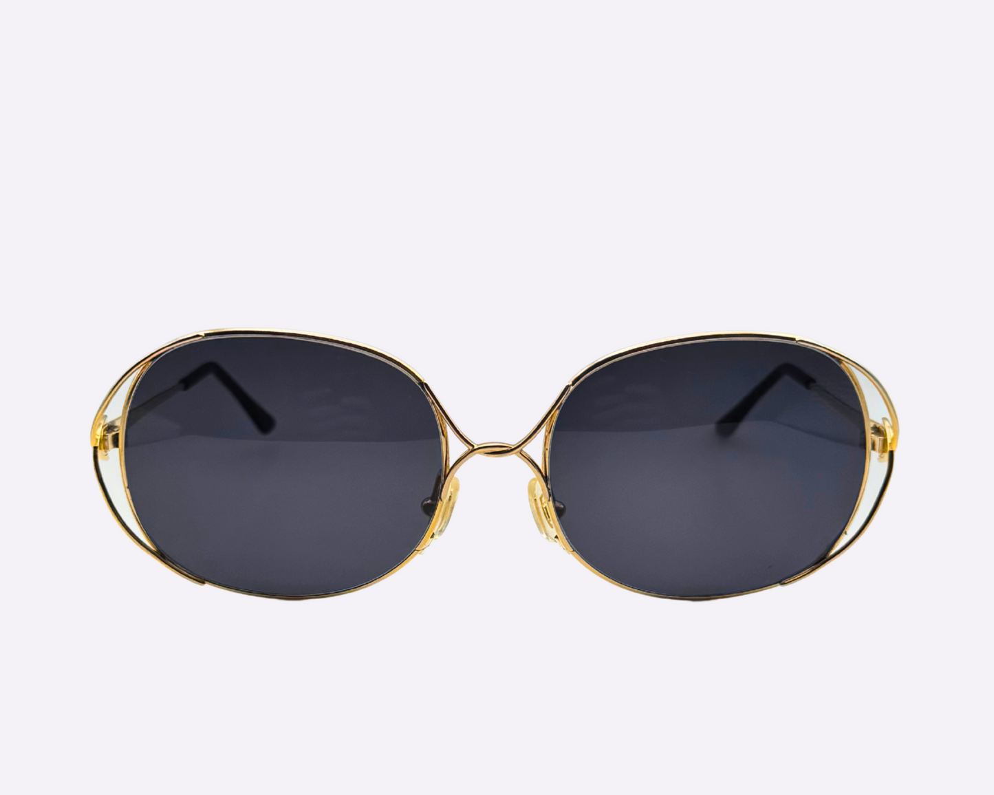 Front view of vintage 1980s Christian Dior sunglasses with a steel frame and new grey lenses, shown on a light gray background.