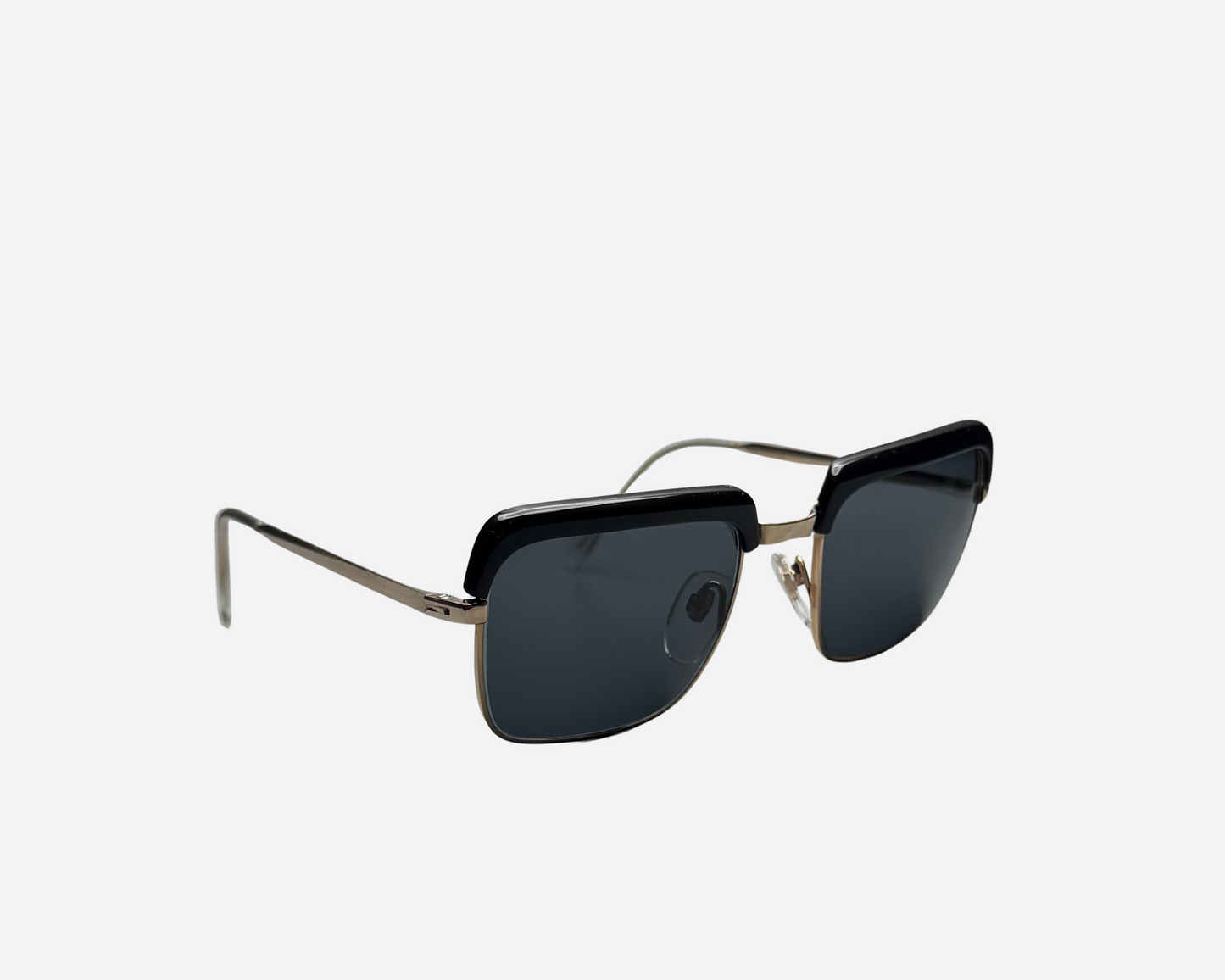 Side view of vintage Indo Windsor sunglasses from the 1980s with black frames, slim metal temples, and brand-new grey lenses, made in Spain.