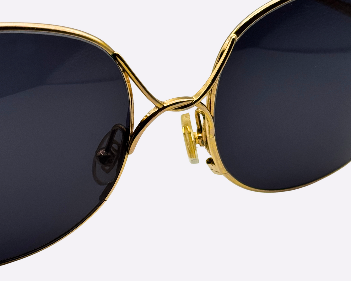 Close-up on the steel nose bridge of vintage Christian Dior sunglasses with new lenses.