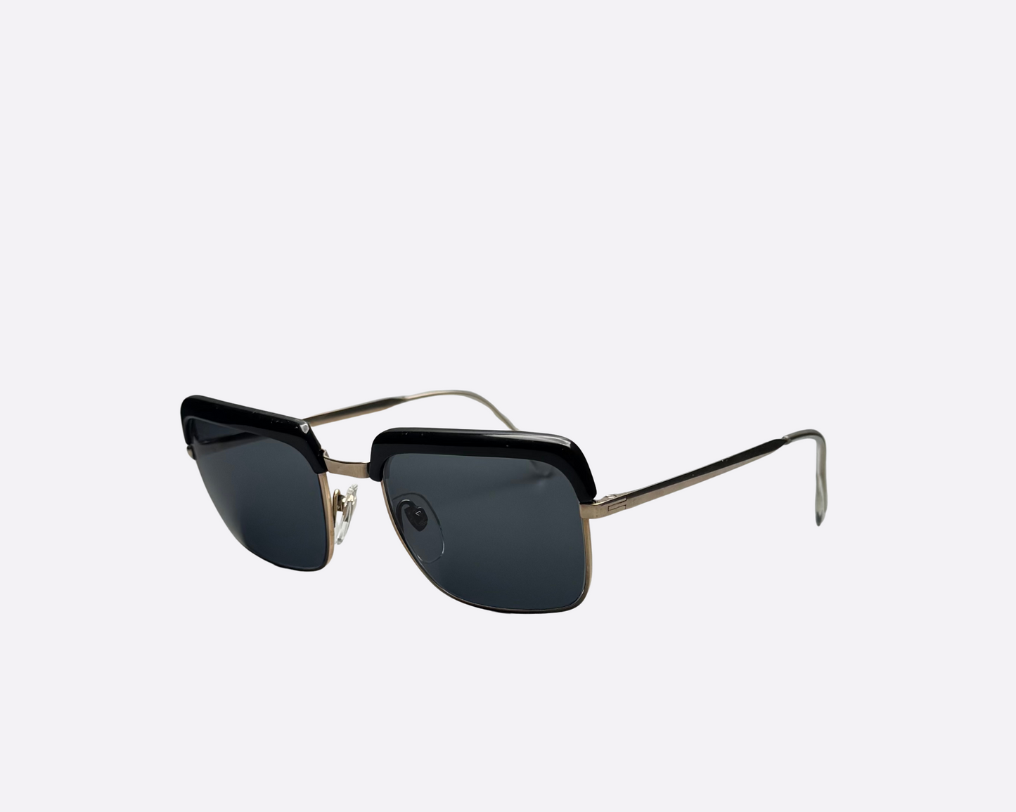 Side view of vintage Indo Windsor sunglasses from the 1980s with black frames, slim metal temples, and brand-new grey lenses, made in Spain.