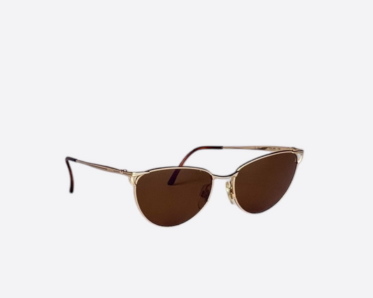 Side view of a pair of Les Copains sunglasses, model LC109, made in Italy, featuring a cat-eye frame design and new brown lenses.