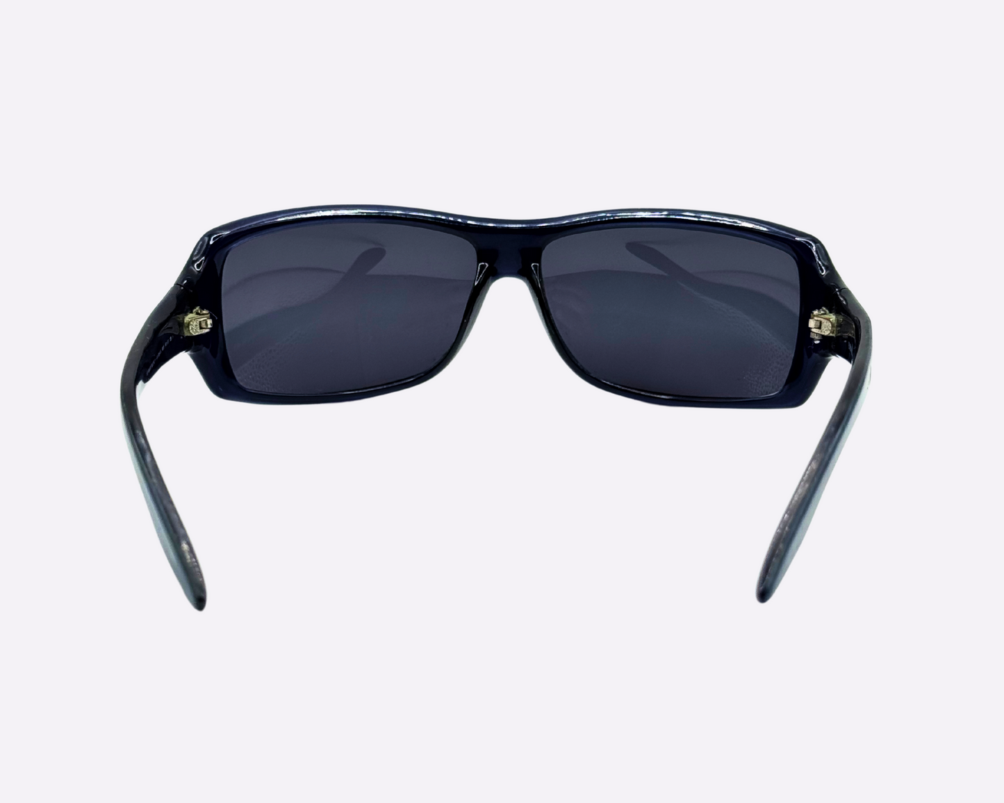 Rear view of early 2000s Armani sunglasses, made in Italy, showcasing a dark blue speckled frame with new grey lenses.