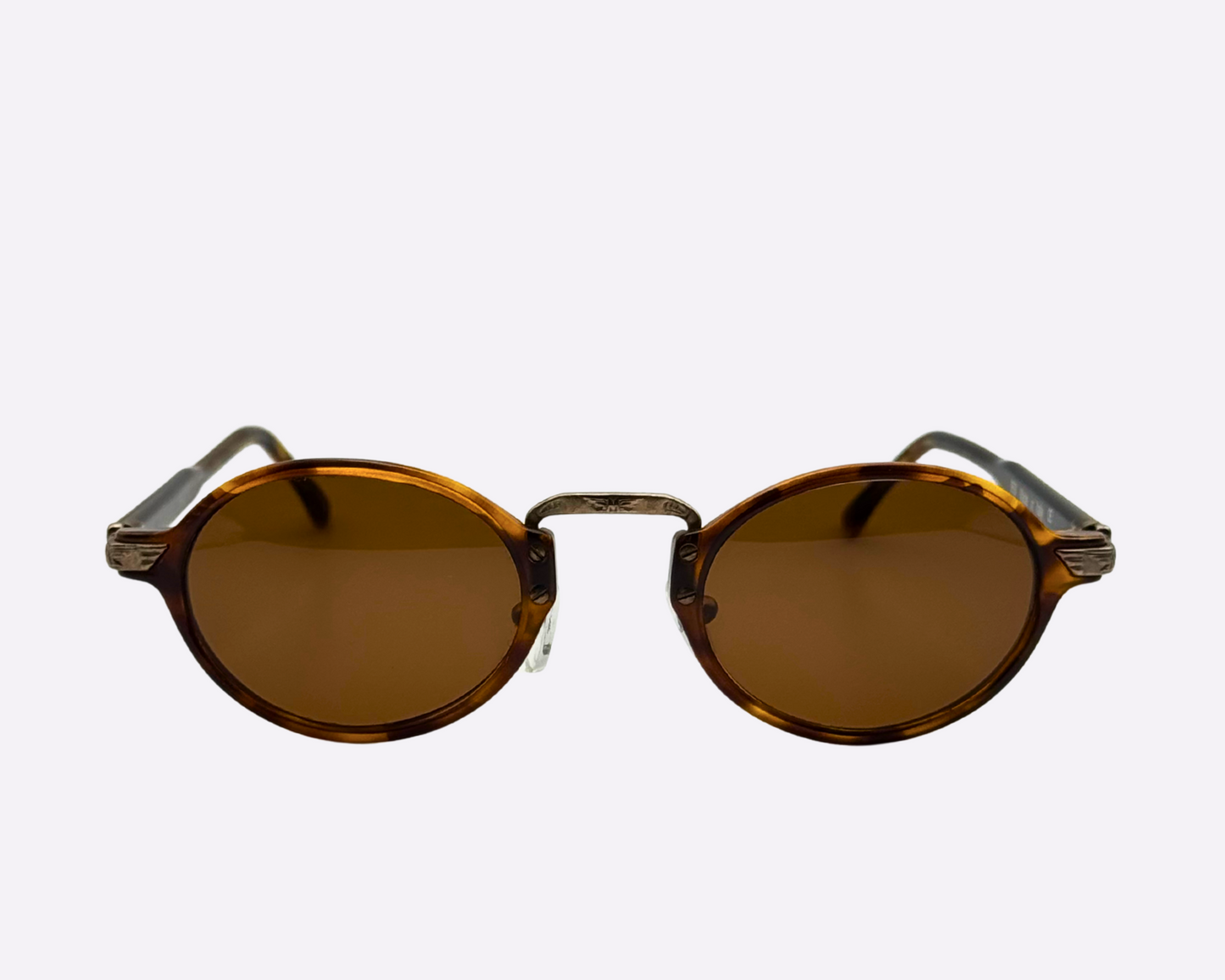Front view of vintage 1990s round sunglasses with brown polarized lenses and a tortoiseshell frame, shown on a white background.