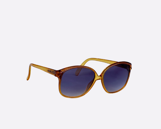 A pair of vintage Terri Brogan sunglasses, model 8786 10, from the 80s with a yellow frame and new grey lenses.
