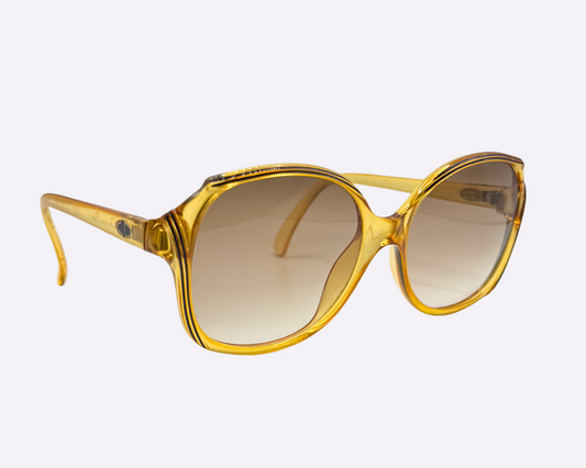 Side view of vintage 1980s Christian Dior sunglasses, model 2130 31, with new brown gradient lenses and made in Germany, shown on a light gray background.