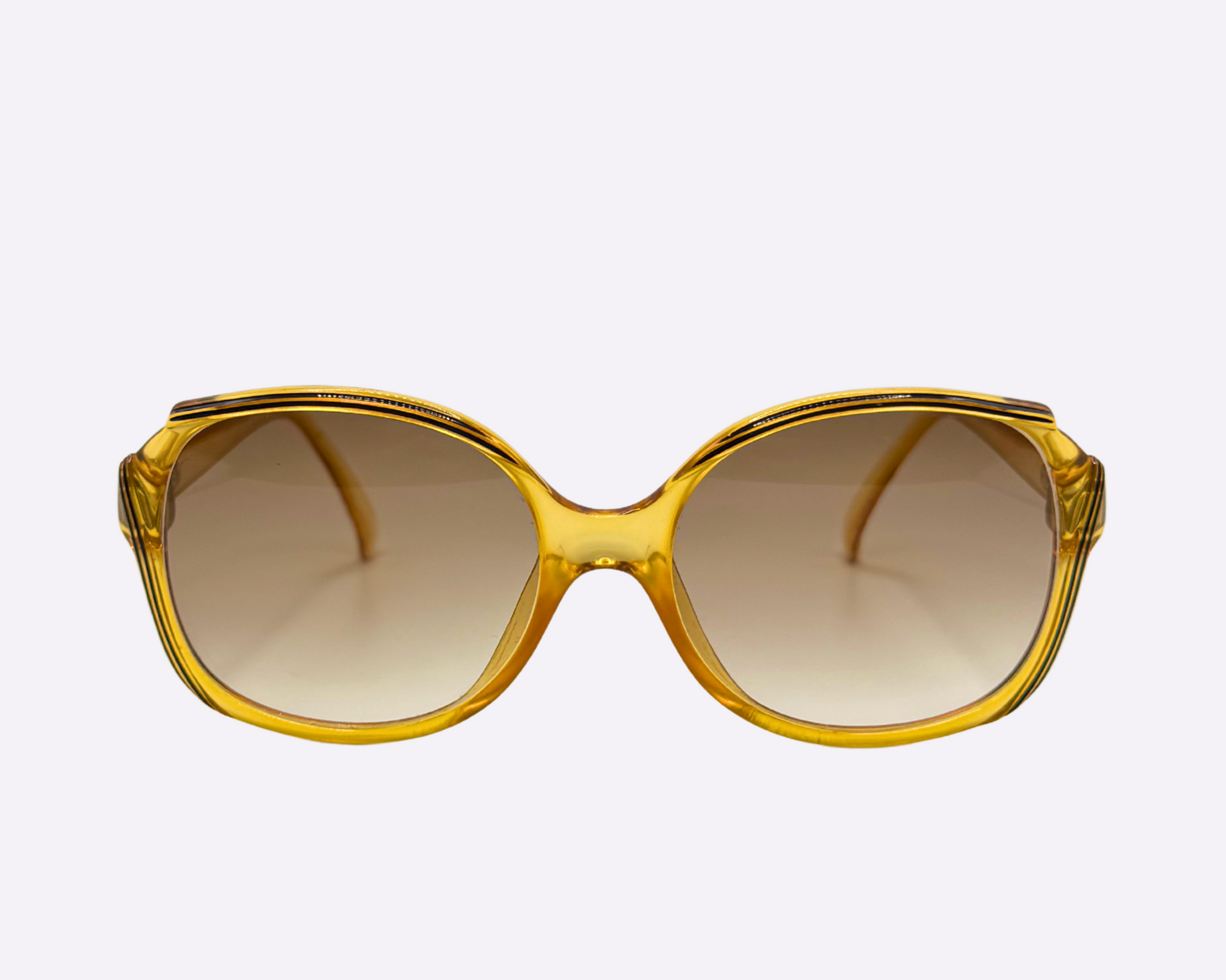 Front view of vintage 1980s Christian Dior sunglasses, model 2130 31, featuring new brown gradient lenses and made in Germany, shown on a light gray background.