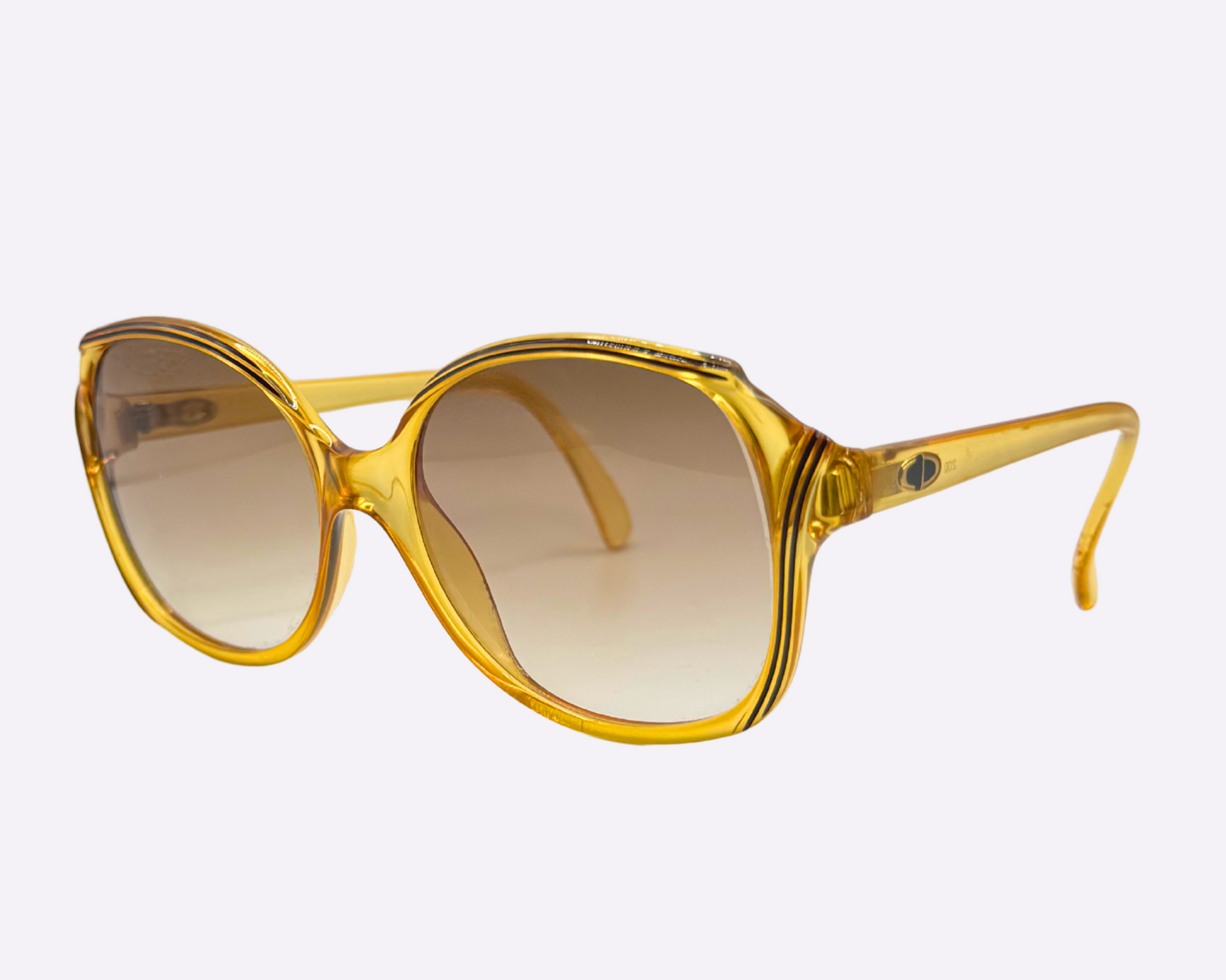 Side view of vintage 1980s Christian Dior sunglasses, model 2130 31, with new brown gradient lenses and made in Germany, shown on a light gray background.