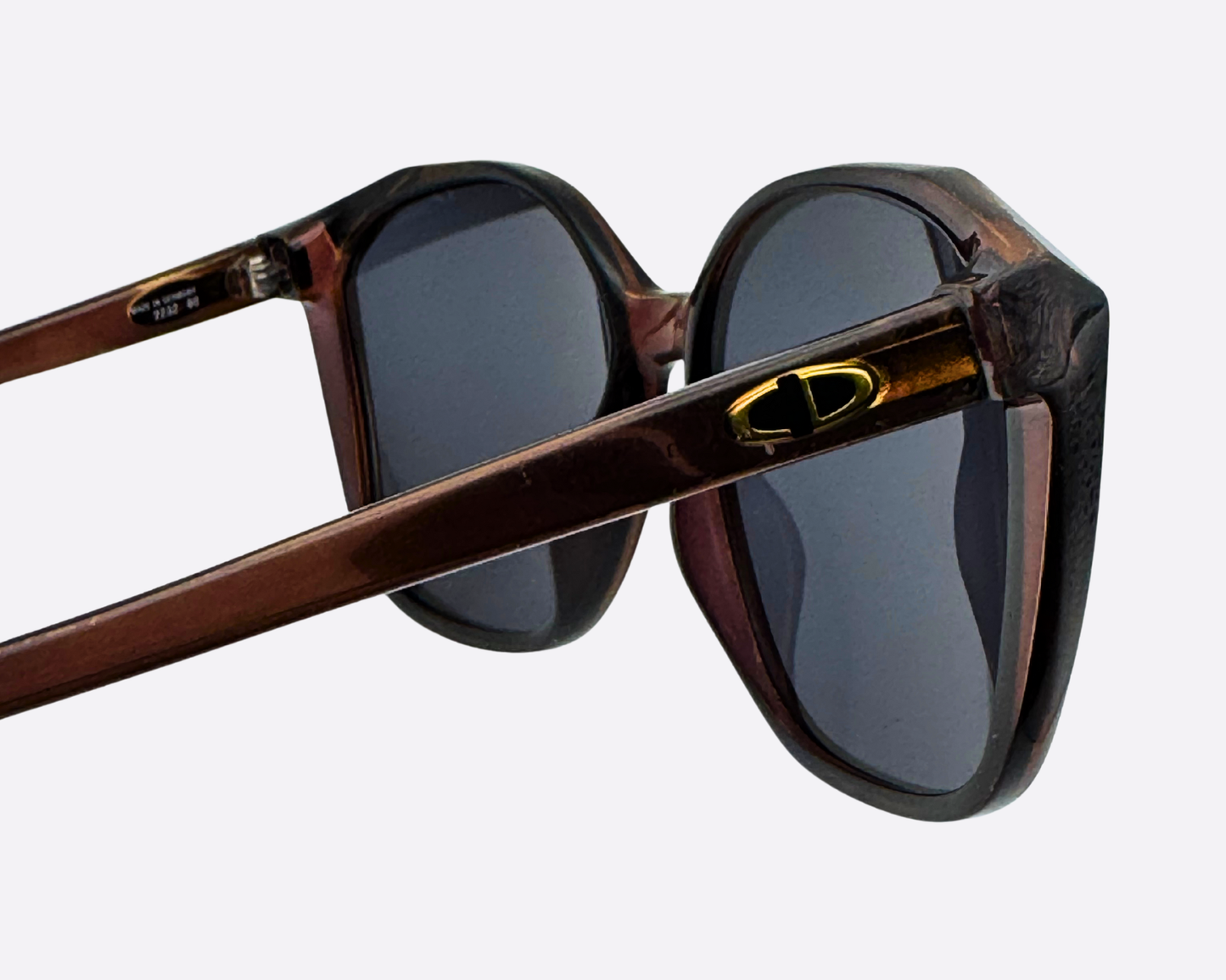 Close-up showing the gold oval Dior logo detail on the thick, brown tortoiseshell temple of the vintage 2232 frame.