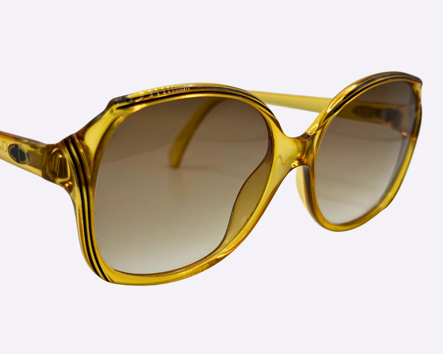 Side view of vintage 1980s Christian Dior sunglasses, model 2130 31, with new brown gradient lenses and made in Germany, shown on a light gray background.