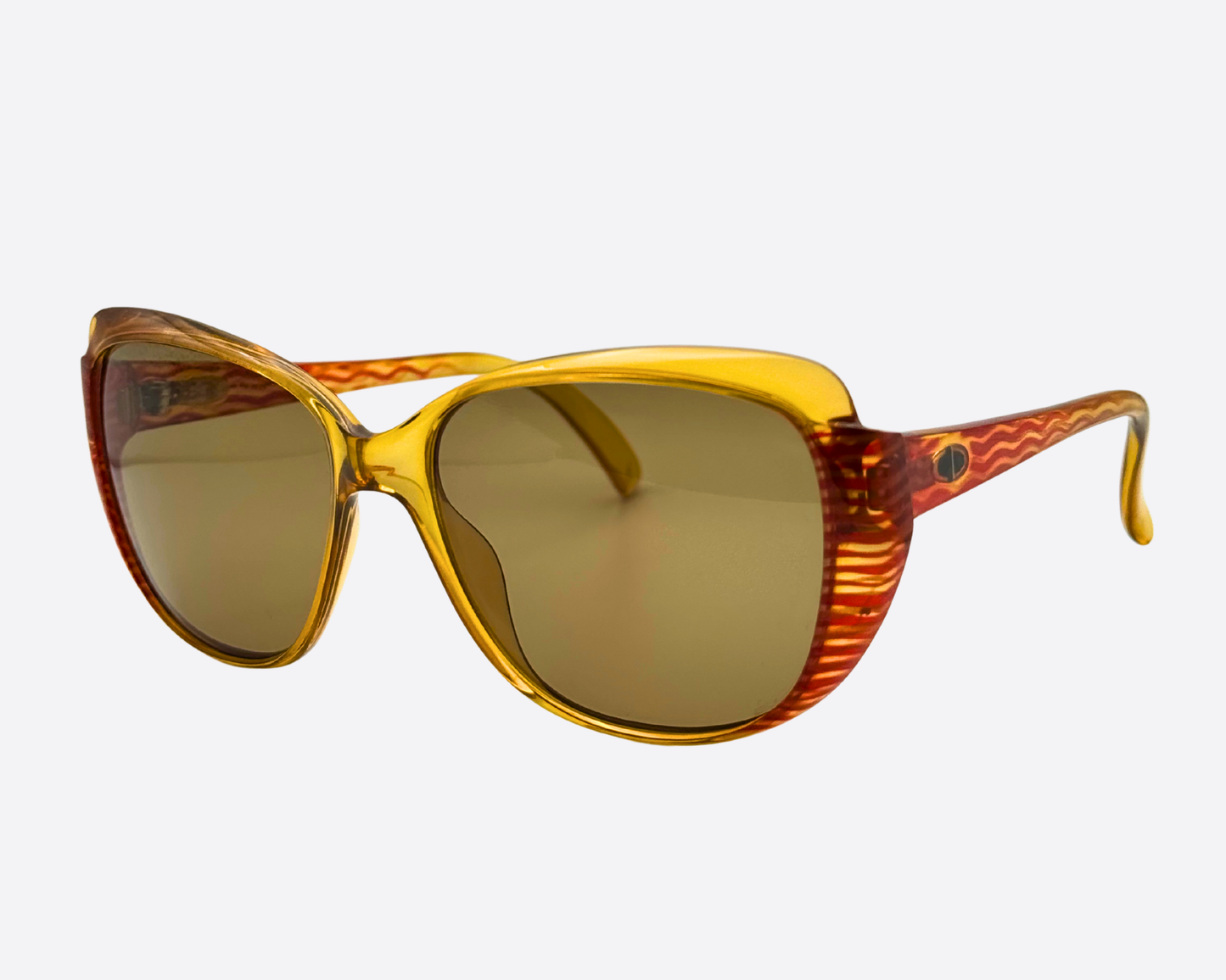 High-angle view of the Christian Dior 2202 30 frame, highlighting the glossy yellow plastic and the wide, cat-eye lens shape with brown lenses.