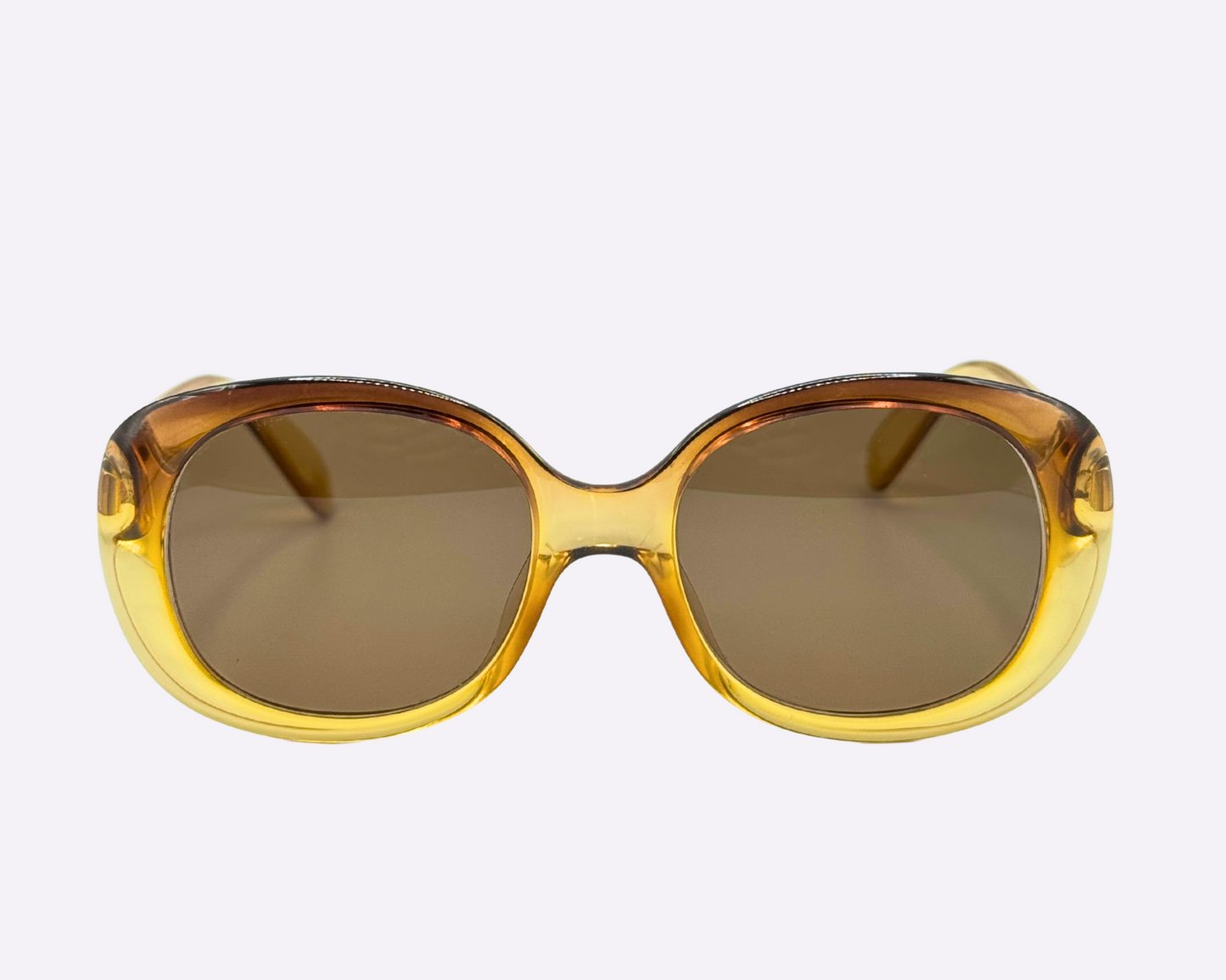 Front view of vintage 1980s Terri Brogan sunglasses, model 8752 80, featuring thick gold optyl frames, shown on a light gray background.