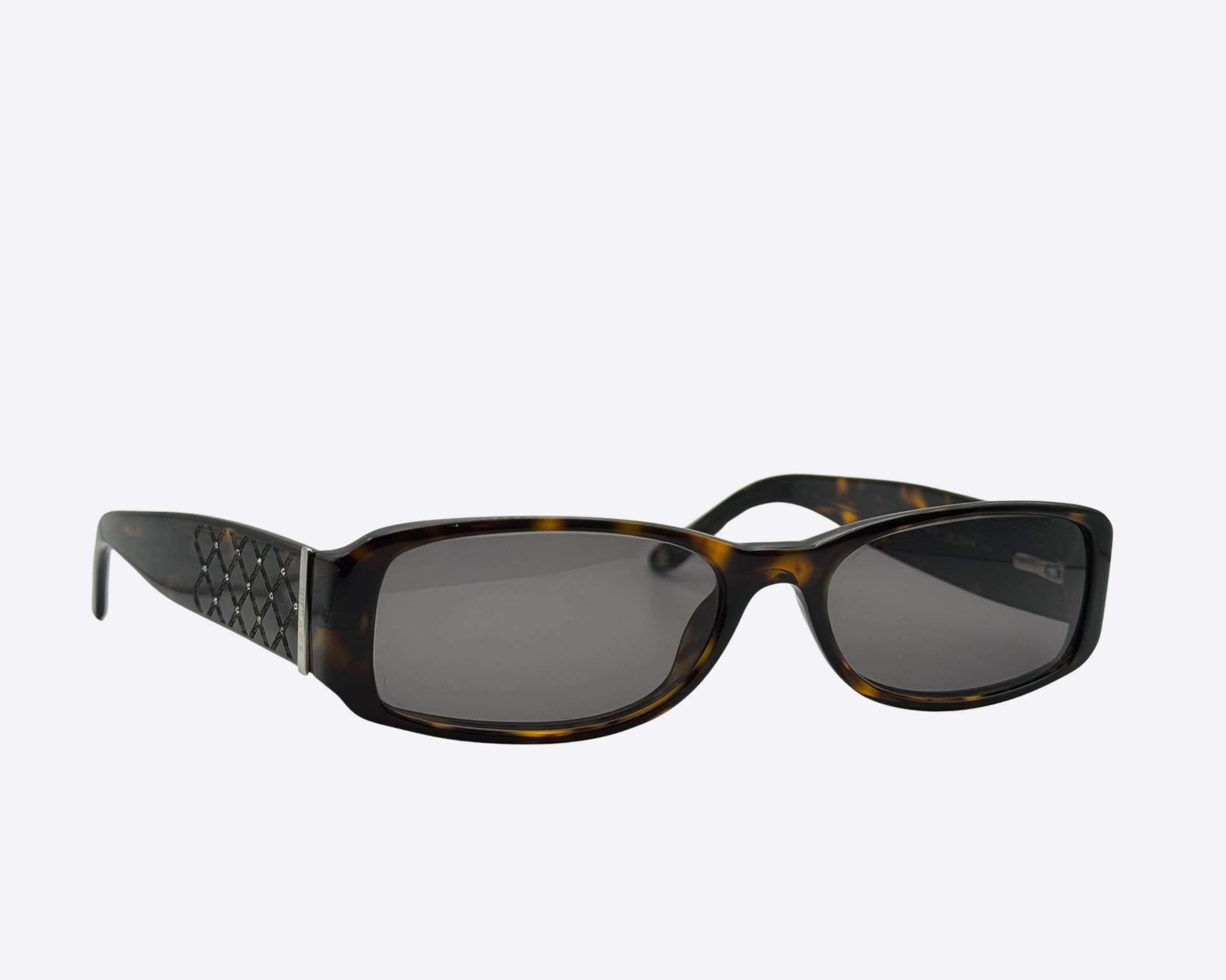Angled view of Versace sunglasses featuring a brown tortoise frame and quilted pattern temples.