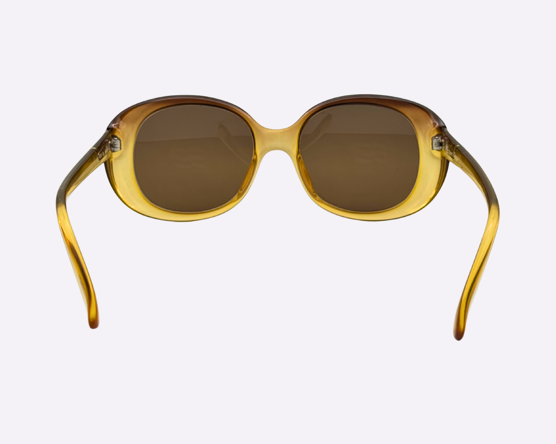 Rear view of vintage 1980s Terri Brogan sunglasses, model 8752 80, featuring thick gold optyl frames and new brown lenses, shown on a light gray background.