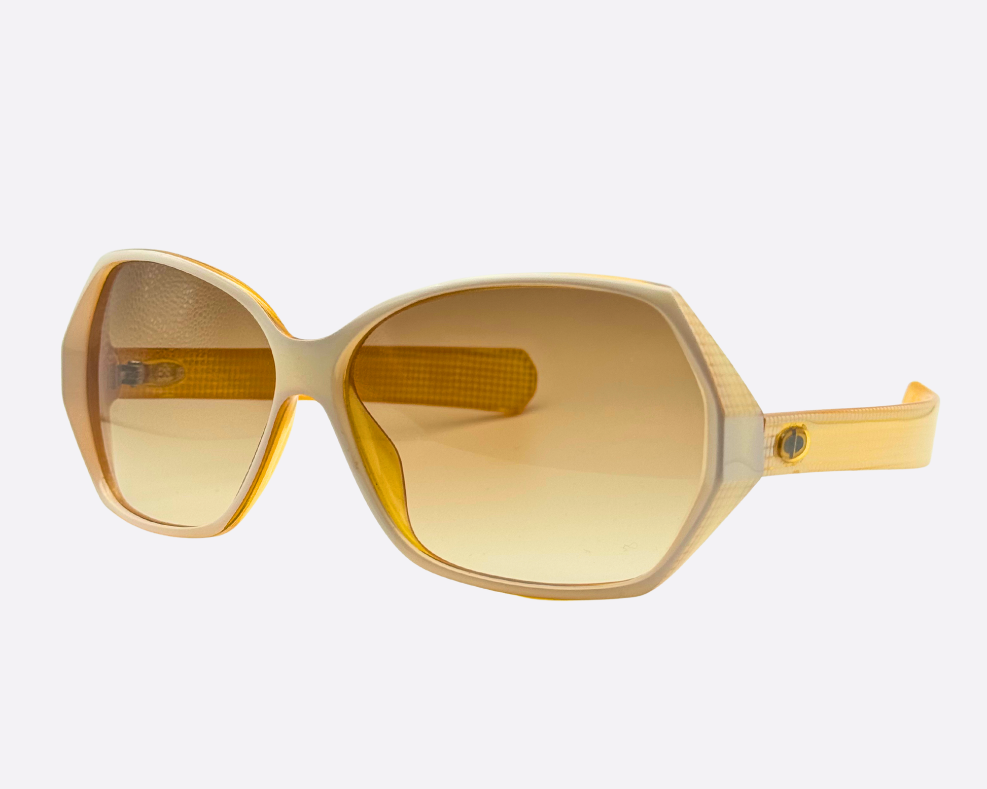 Angled view of the vintage Christian Dior 2177 sunglasses from the 1980s. The wide white and gold hexagonal frame features new brown gradient lenses and the signature 80s profile.