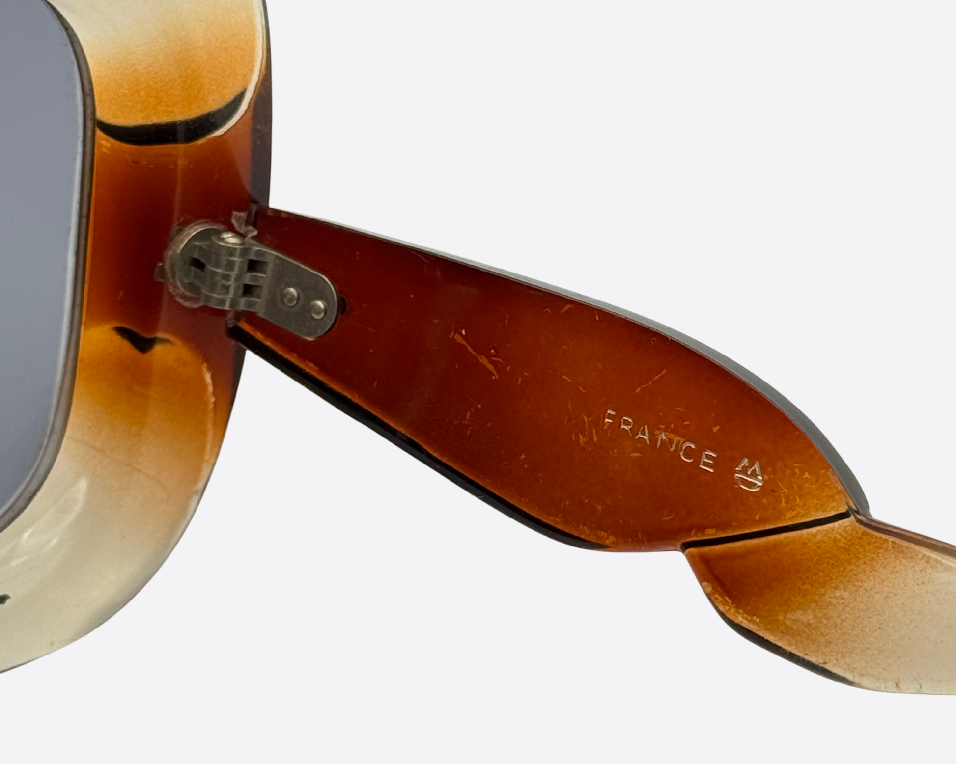 Close-up of the inner hinge and 'FRANCE' engraving on vintage 70s oversized sunglasses, showcasing authentic French craftsmanship.