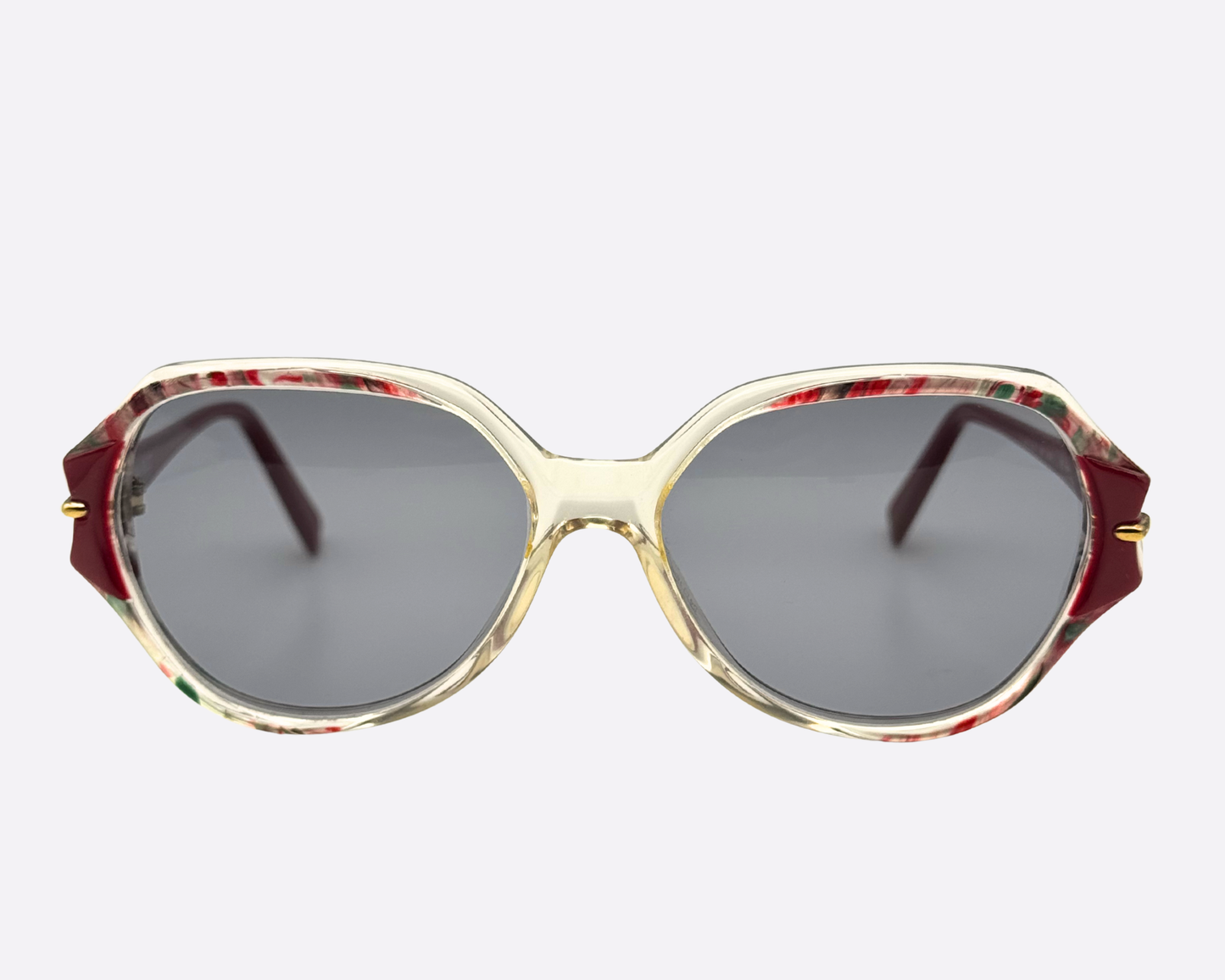 Vintage Nina Ricci 2406 sunglasses, 80s French couture eyewear, octagonal translucent frames with red and green accents and grey UV lenses.
