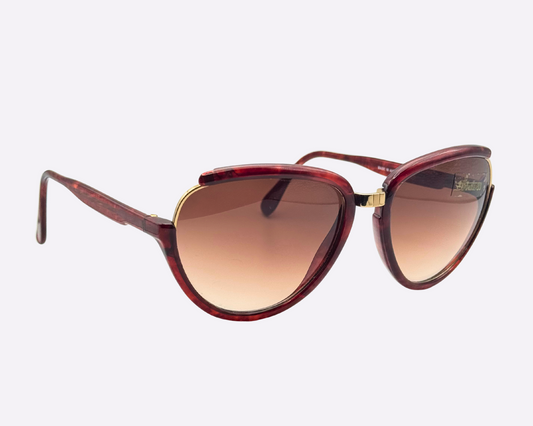 Side view of vintage 1980s Silhouette M8023/20 cat-eye sunglasses featuring a gold and tortoise frame made of optyl and metal, with original brown gradient lenses, shown on a light gray background.