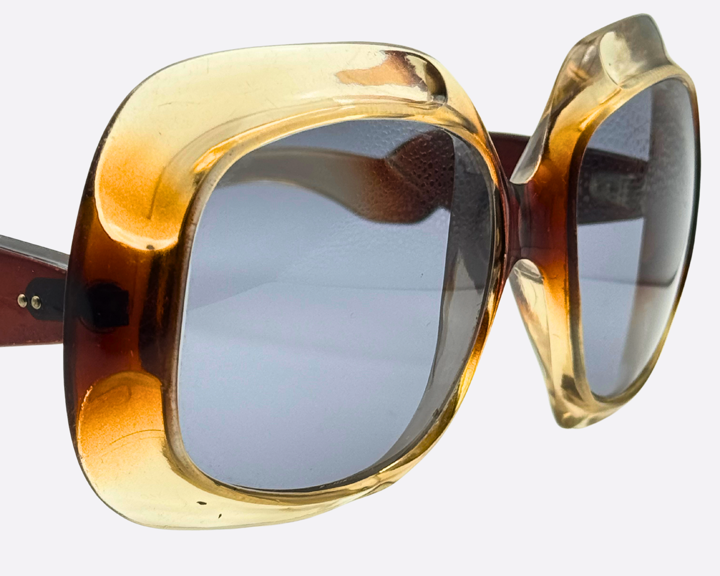 Three-quarter angle of massive 1970s maximalist sunglasses, highlighting the bold acetate construction and Studio 54 glamour aesthetic
