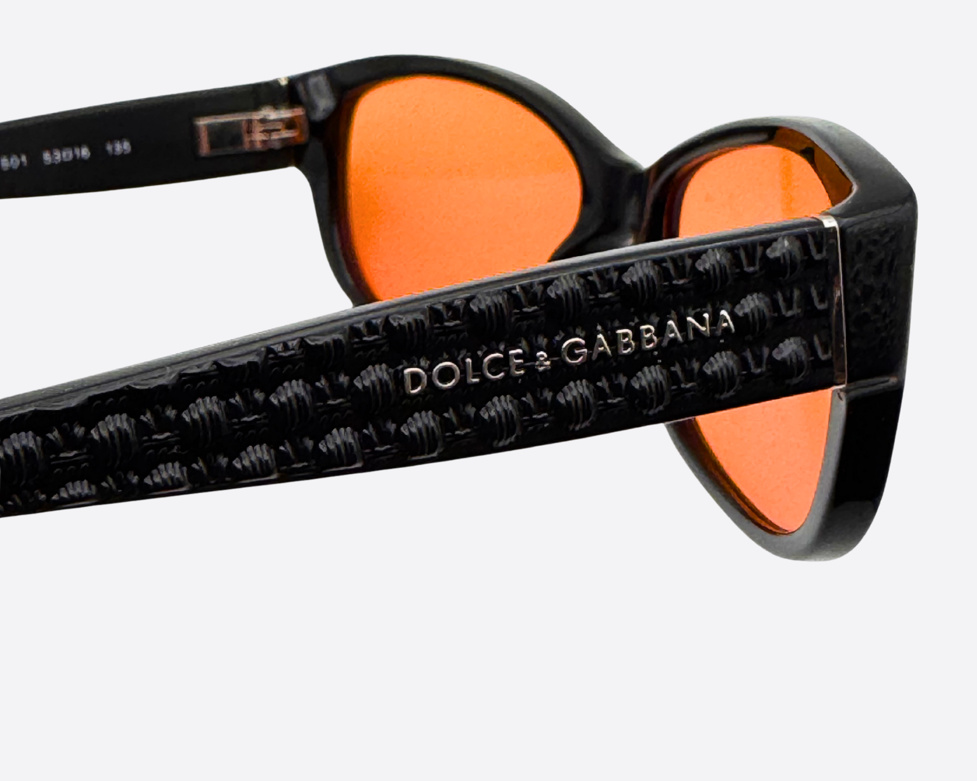 Detailed close-up showing the Dolce & Gabbana embossed logo on the black textured temple of the vintage DG3125 frame.