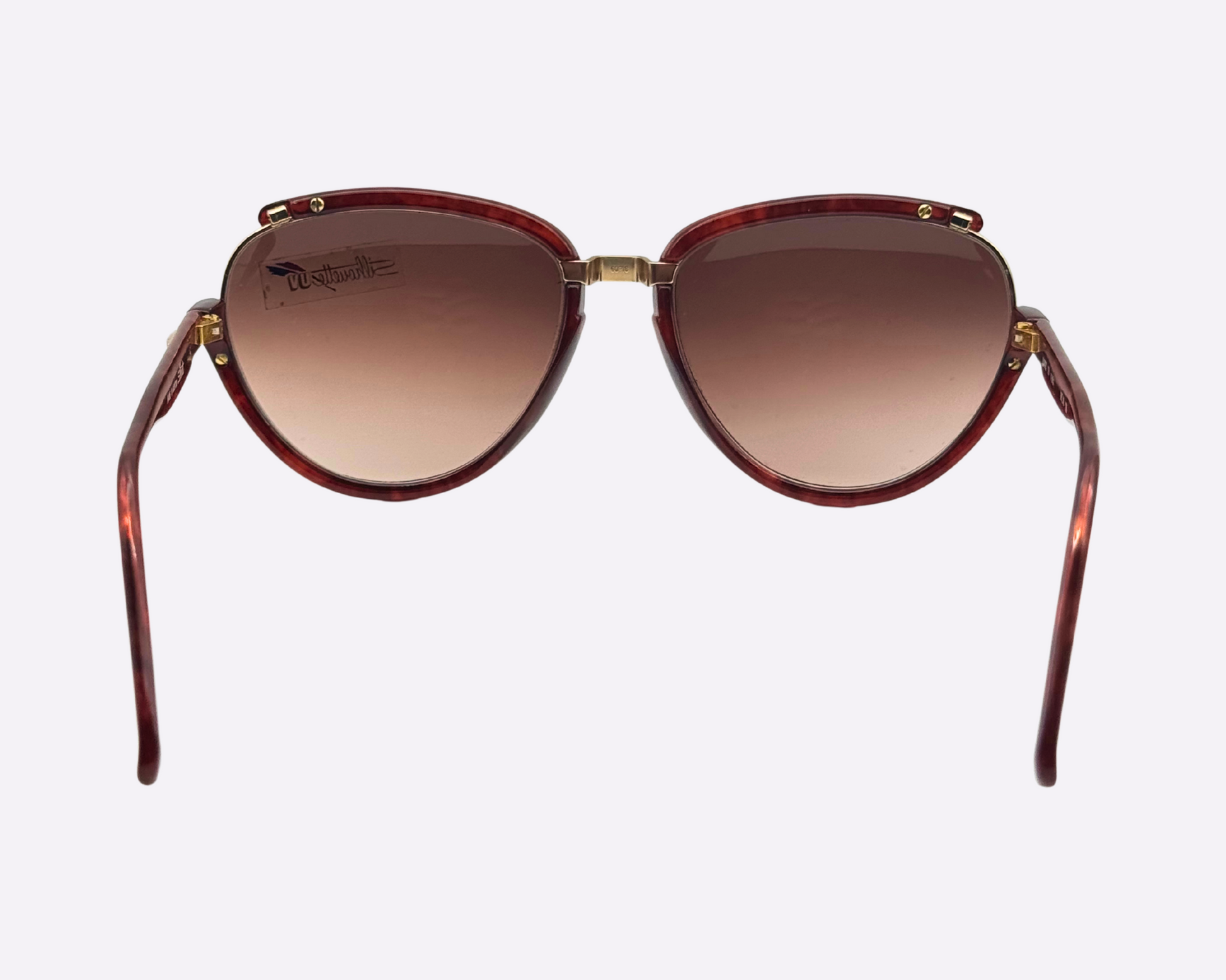 Rear view of vintage 1980s Silhouette M8023/20 cat-eye sunglasses with a gold and tortoise frame in optyl and metal, and original brown gradient lenses, shown on a light gray background.