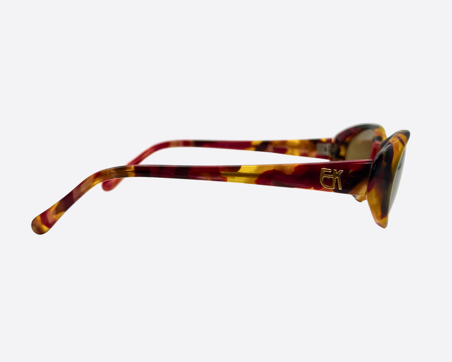 Side view of Emmanuelle Khanh 2018-12 vintage sunglasses, showing the thick multi-colored tortoiseshell temples and gold-tone designer logo, Made in France.