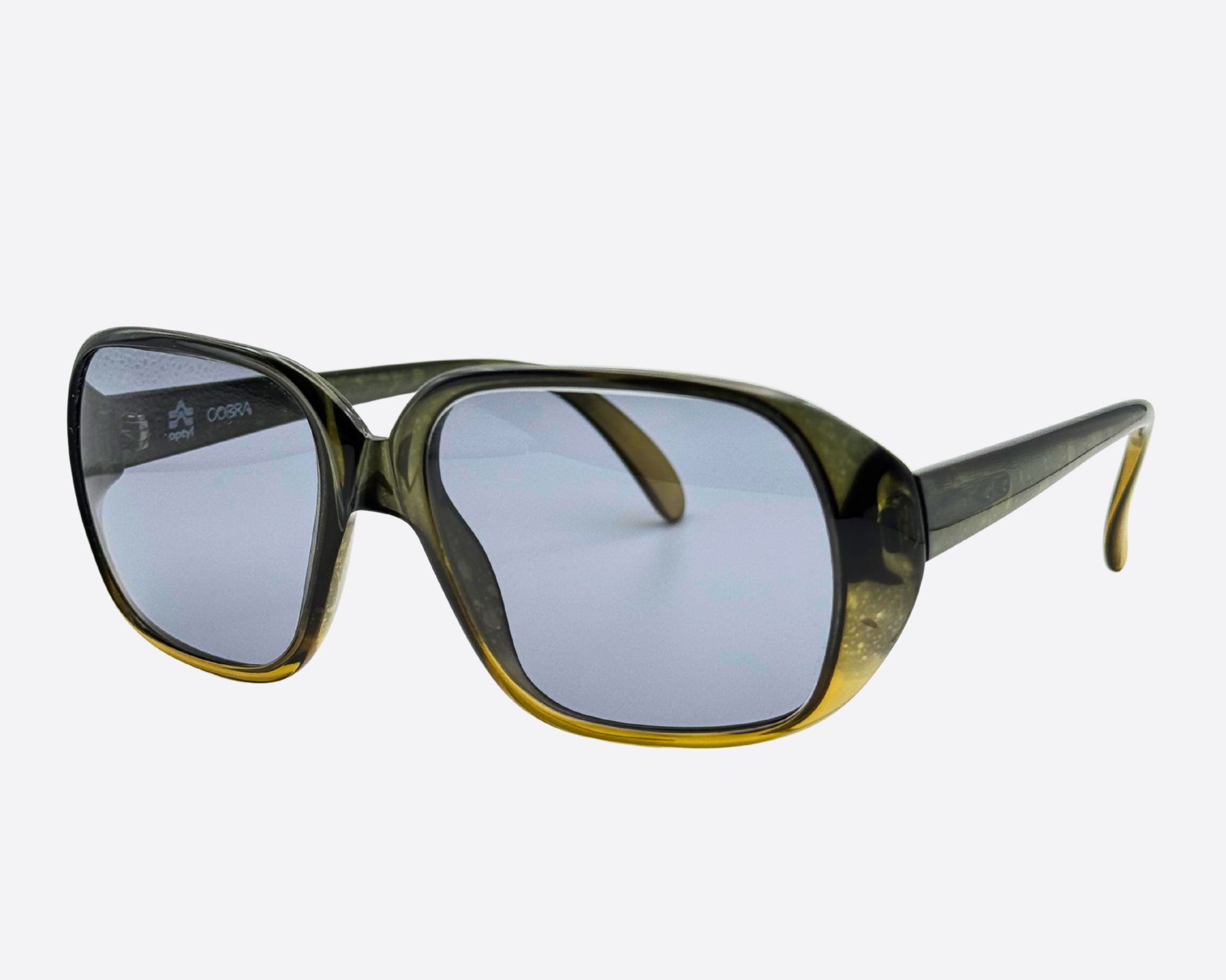 Angle view of Austrian-made Cobra 3036 sunglasses, showing the medium-sized translucent frames and the distinct 70s khaki and yellow color transition.