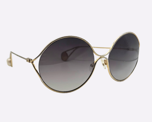 Side view of Gucci oversize sunglasses featuring a steel frame and new grey lenses, shown on a white background.