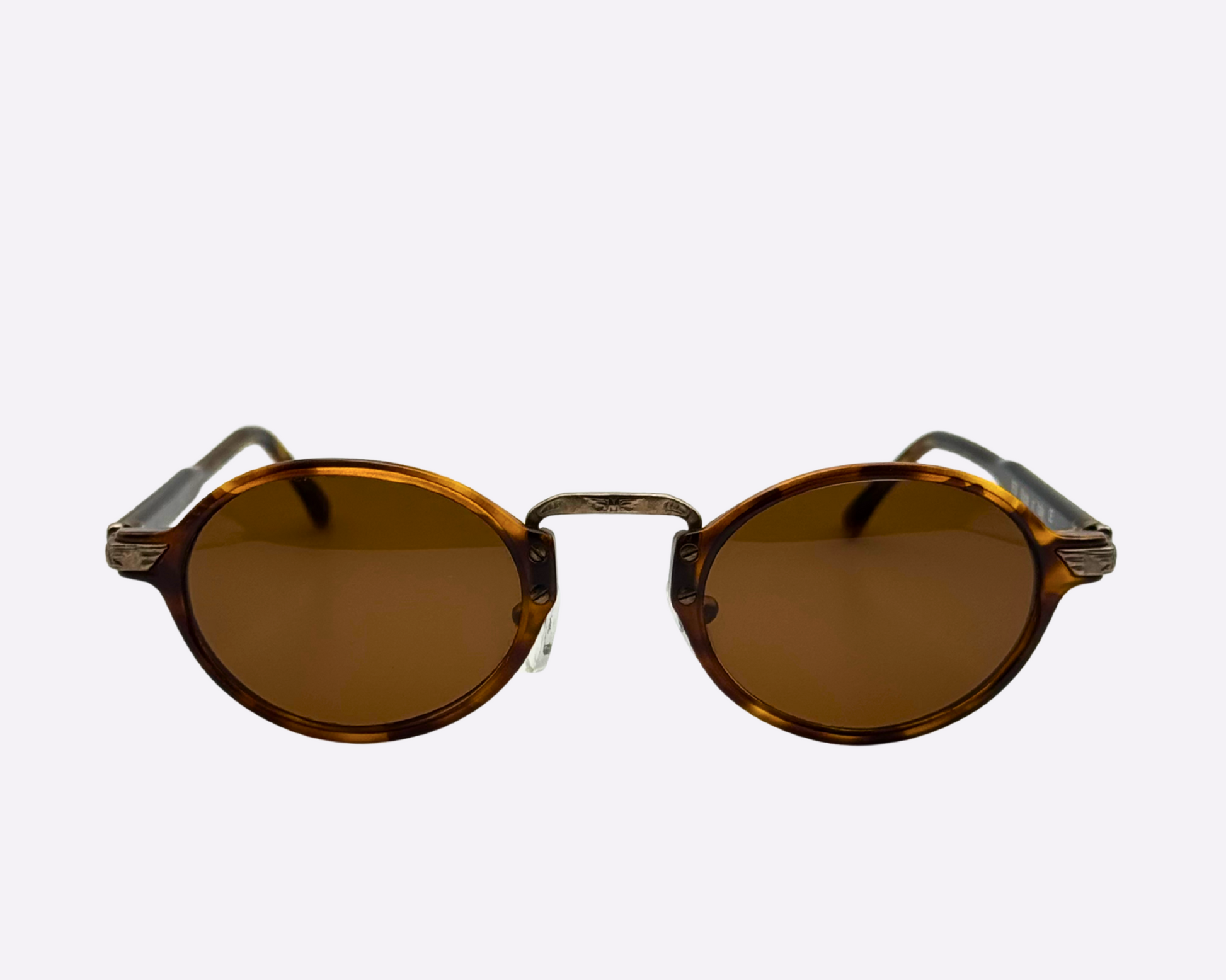 Front view of vintage 1990s round sunglasses with brown polarized lenses and a tortoiseshell frame, shown on a white background.