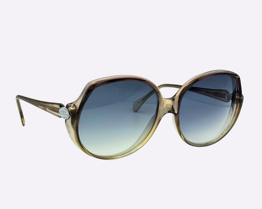 Vintage 1980s Indo sunglasses with oversized round frame and gradient blue lenses, side view showcasing JL logo on the temple.