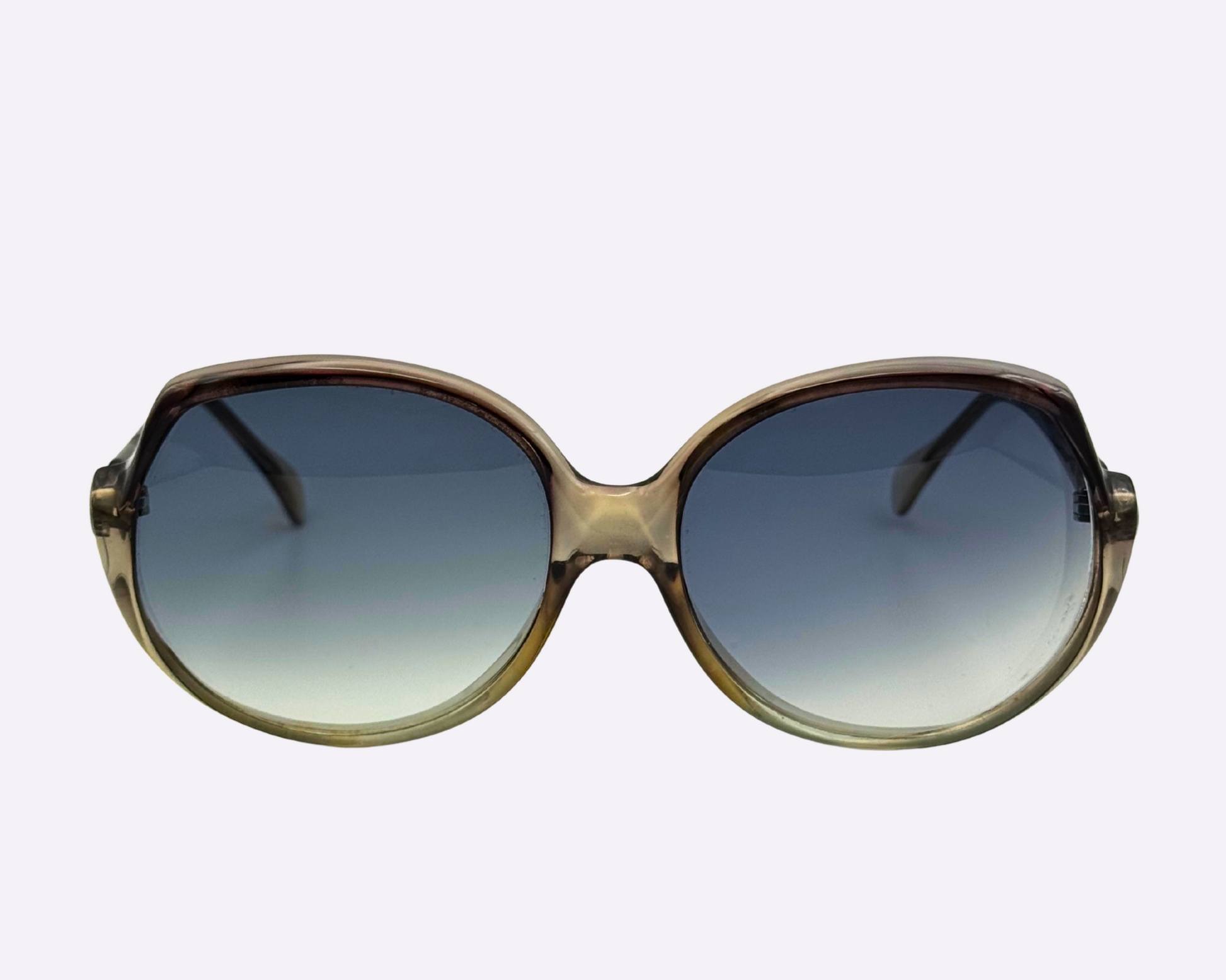 Front angled view of vintage 1980s Indo sunglasses featuring large round frame in grey acetate and gradient grey/blue lenses.