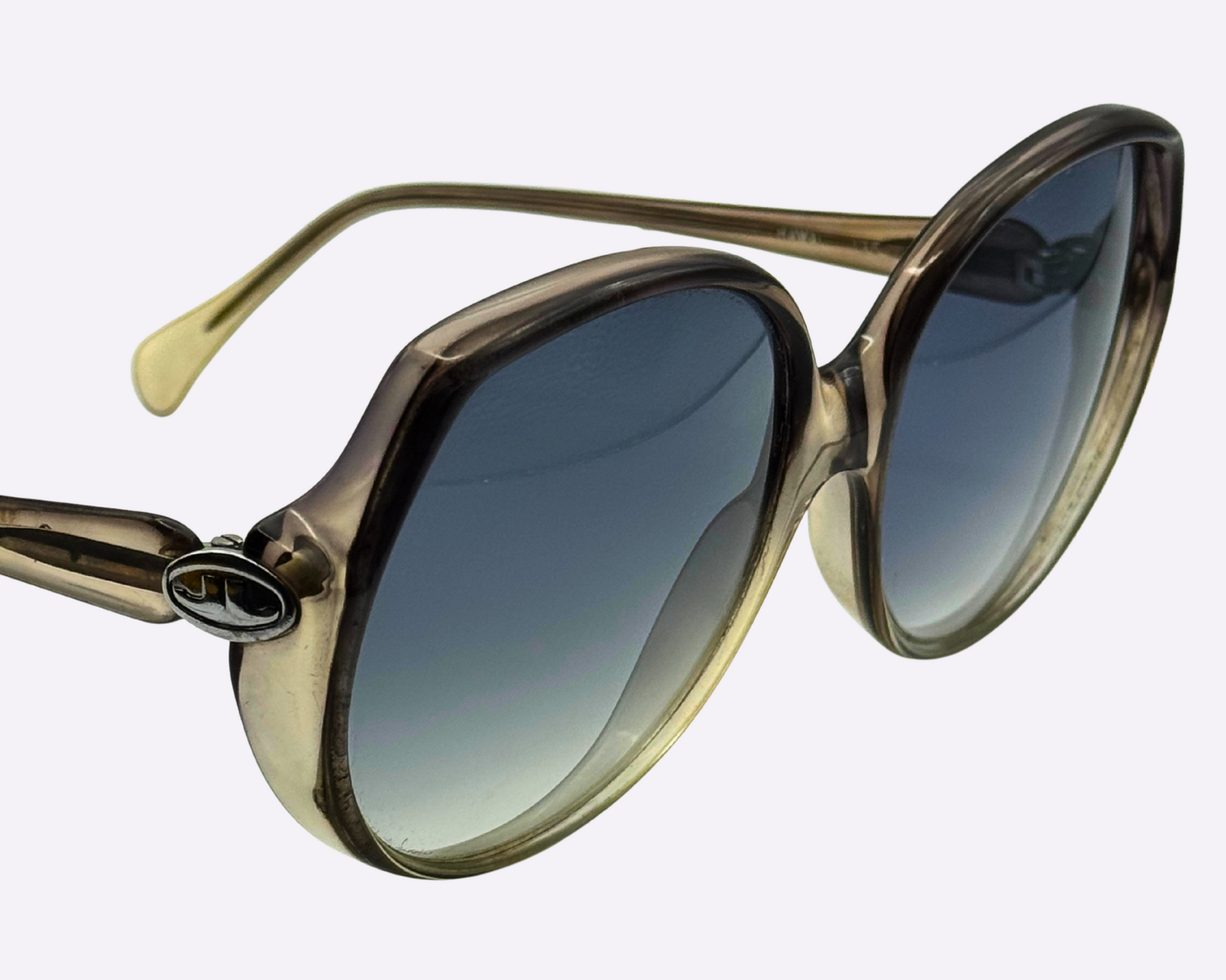 Close-up view of 1980s Indo sunglasses showing JL logo on the temple and fitted with new grey-blue gradient lenses.