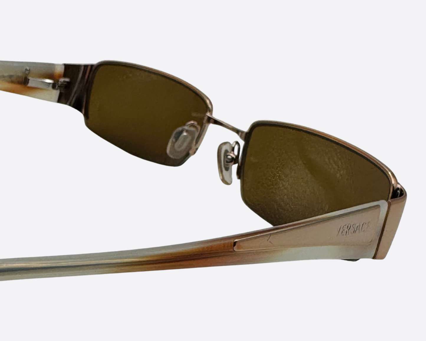 Interior view of Versace sunglasses showing the nose pads and the high-quality metal construction.