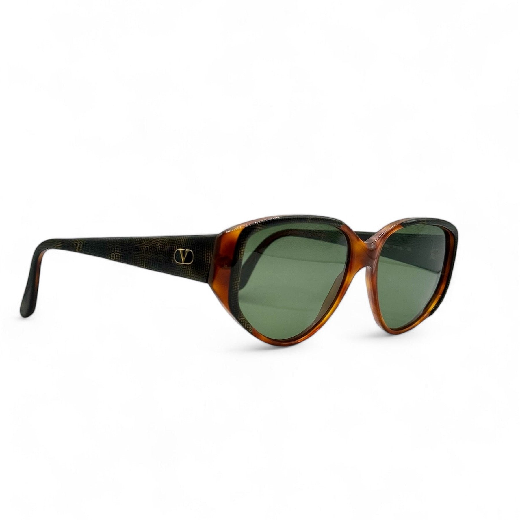 Side view of vintage 1980s sunglasses by Valentino, featuring brand new vibrant green lenses and an exotic reptile-skin pattern on the frame, showcasing excellent Italian craftsmanship.