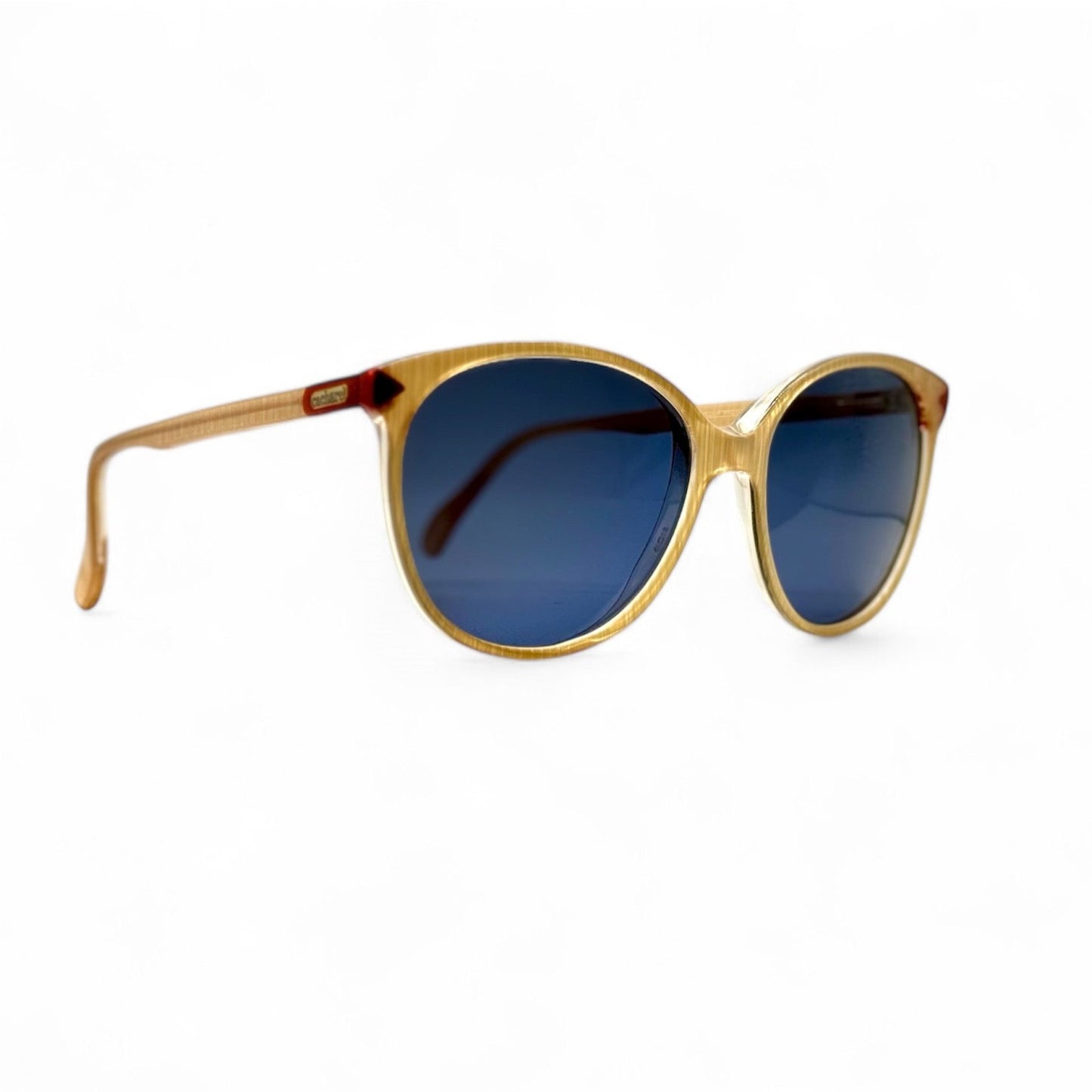 Right side view of vintage Cacharel sunglasses highlighting the elegant contours of the 80s recycled frames in a refined beige tortoiseshell hue, made in France. Paired with new blue UV400 lenses for optimal eye safety.