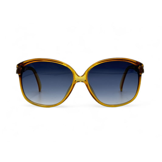 Front view of vintage Terri Brogan sunglasses from the 80s, crafted from lightweight Optyl material. Featuring gradient blue/grey UV400 lenses for stylish sun protection, combining retro charm with modern functionality.