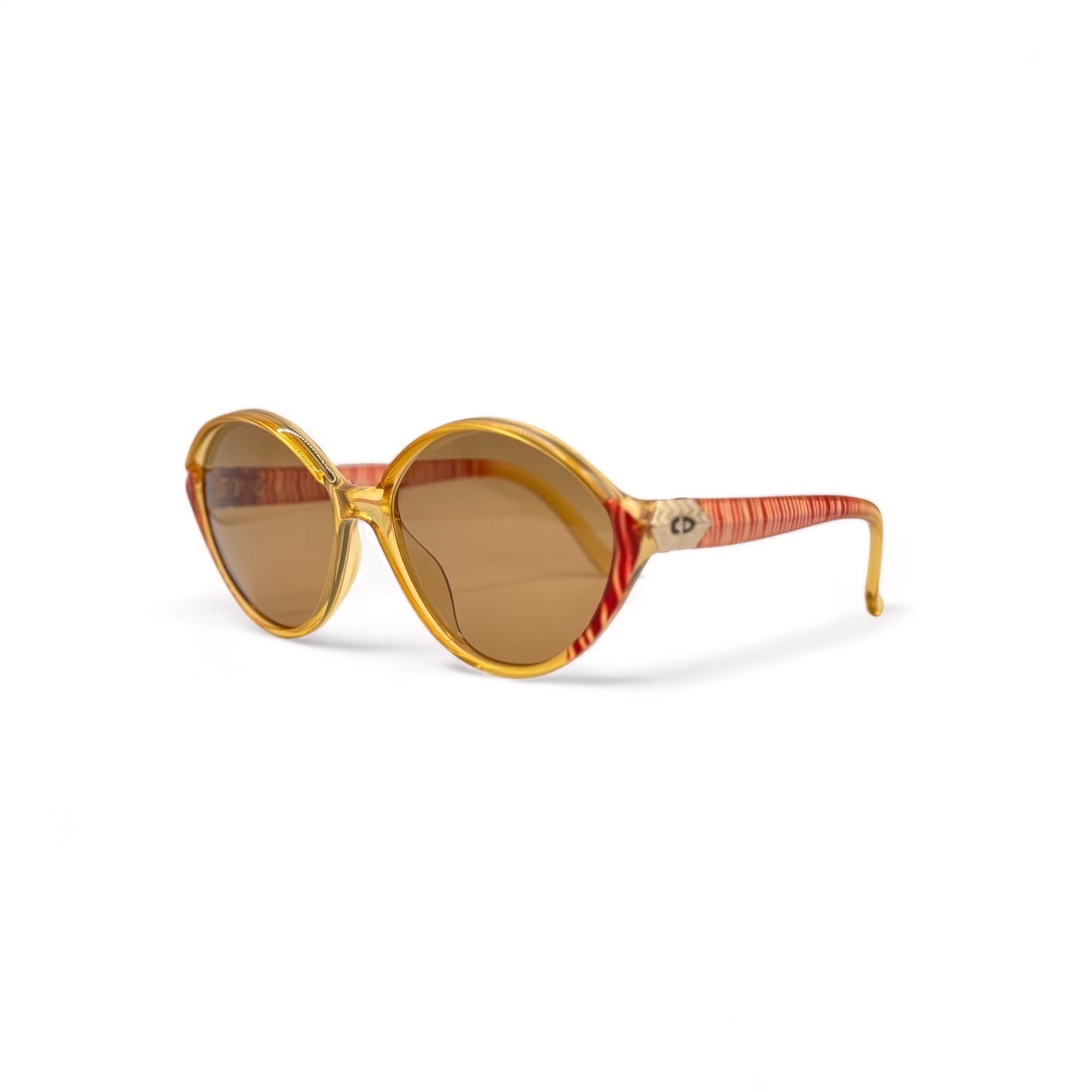 Side view of Christian Dior eyewear, showcasing the iconic gold and red zebra striped frame and gold-plated temples with the CD logo. New brown UV400 lenses offer both style and superior sun protection.