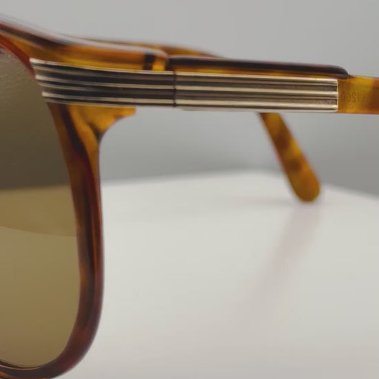Video of vintage Viennaline 1200 sunglasses, rotating to show the glossy tortoiseshell finish, the geometric aviator shape, and the brand-new brown sun lenses from every angle.